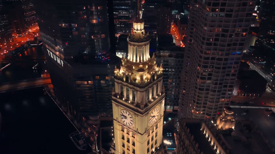 Chicago riverfront and illuminated Wrigley Building at night